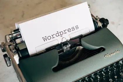 The word WordPress typed onto a sheet of paper in a typewriter.